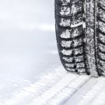 Tire in snow showing when to replace winter tires