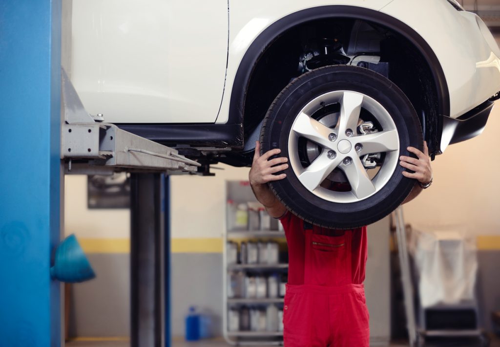 mechanic exchanging car tire