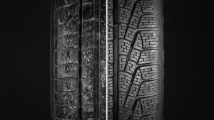 Comparing a new tire with an old, worn out tire.