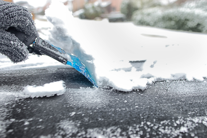 Ice scraper clearing snow