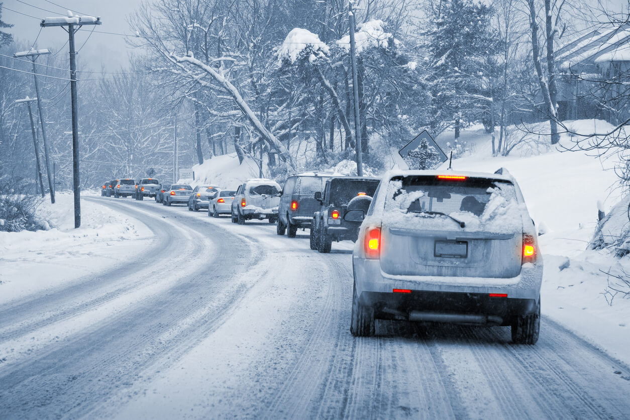 A line up of cars on a snowy road