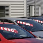 Row of used cars with prices on the windscreen