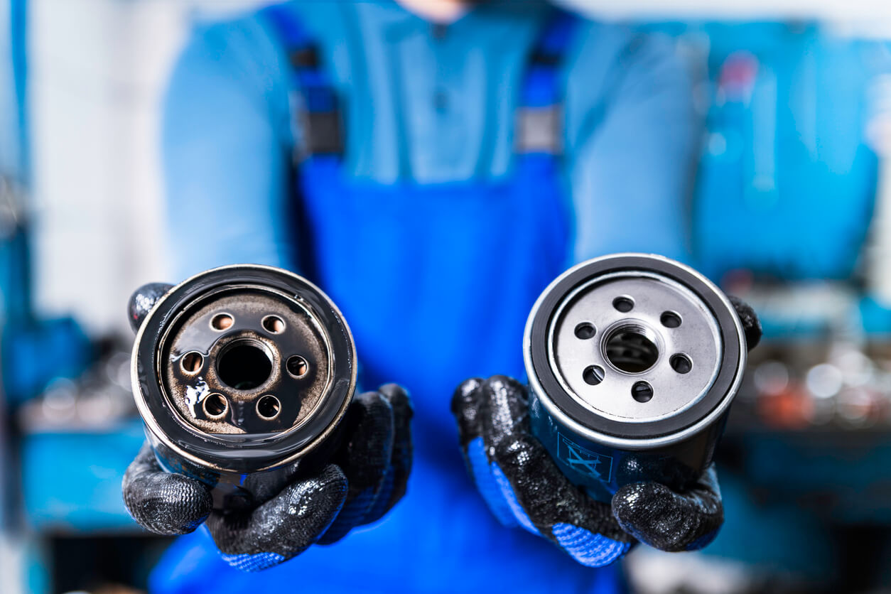 A new and used oil filter used to demonstrated new vs used parts