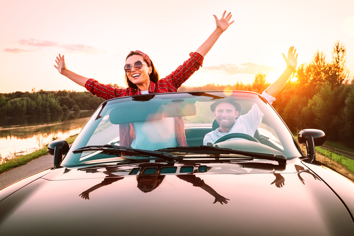 Happy couple in a convertable. 