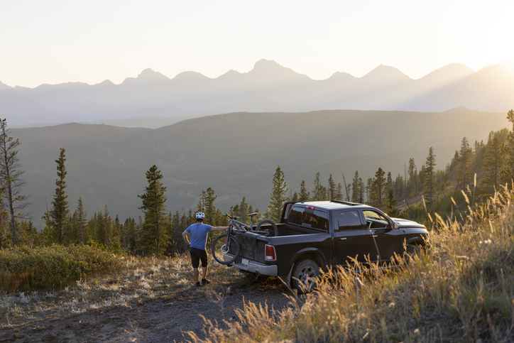 Mountain biker with truck in the country.