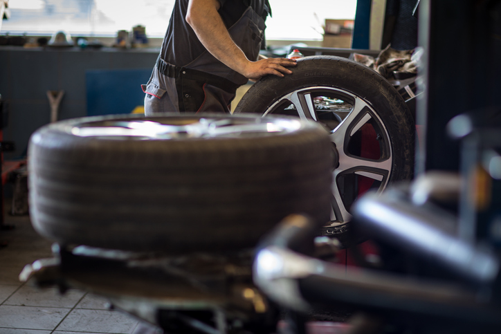 Wheel balancing or repair and change car tire at auto service garage.