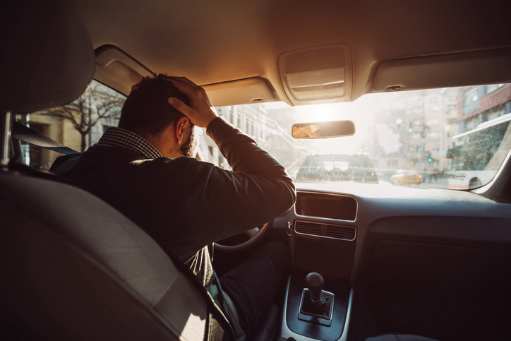 Man frustrated driving a car.