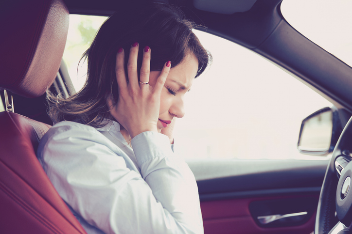 Stressed woman driver sitting inside her car.