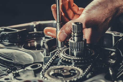 Hand adjusting gears in car.